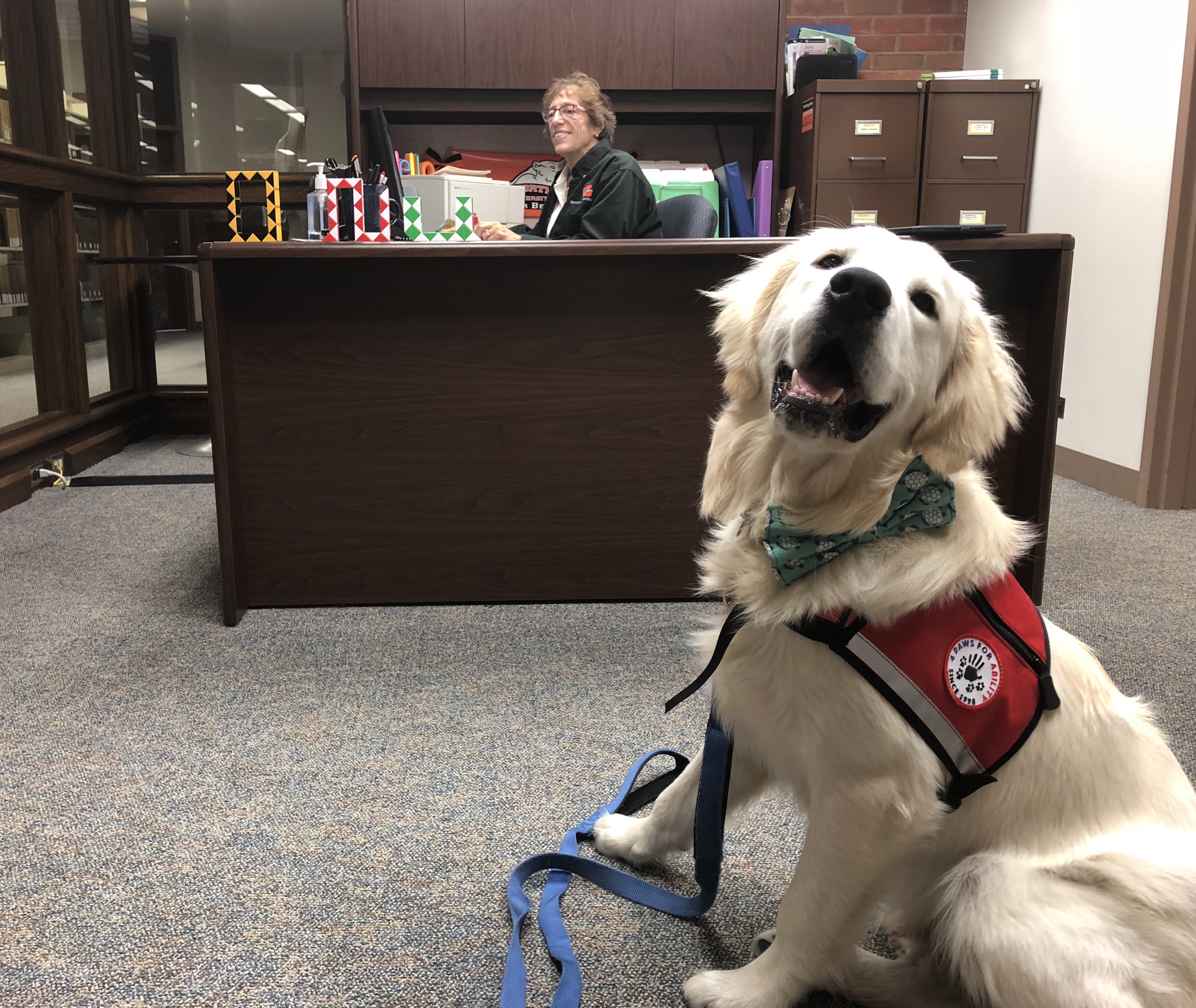 Polar Paws dog greets visitors during the open house with the Writing Center's administrative assistant, Sandra Elsass. (Northern Review photo/McKenzie Wilson)