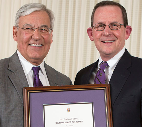 President DiBiasio poses with William Martin at the Greek Awards Ceremony. (photo/Trevor Jones)