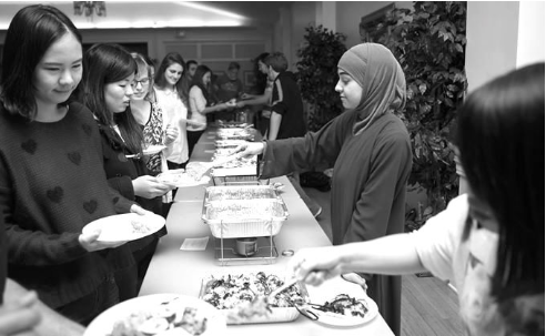 WSO executive members serve food to the many attendees in line. (ONU photo/Trevor Jones)