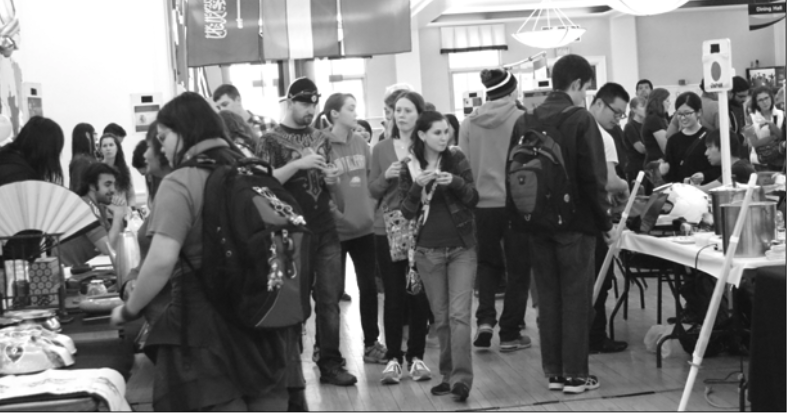 Attendees walk through the aisles to see the different booths at the 2015 annual Multicultural Fair. There were 15 tables overall, each representing International students or organizations on campus. (Northern Review photo/Khadijah Bagais)