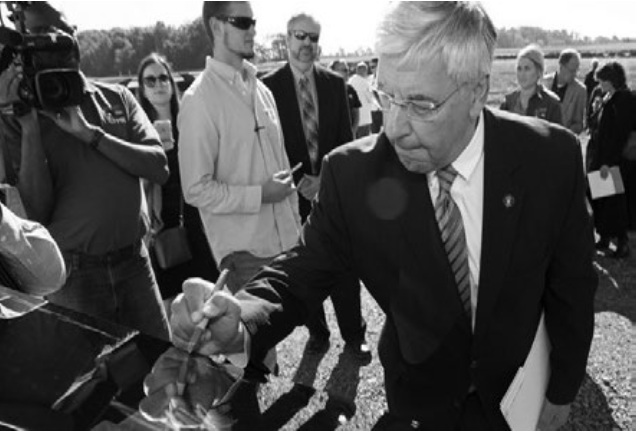 President DiBiasio and others signing the ceremonial solar panel at the groundbreaking ceremony of the solar field off of Klinger Rd (Photo/Communications and Marketing).