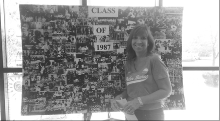 Lorrie Bianco smiling through the memories of the 80s with a collage of photos displayed at Kinghorn during the alumni tailgate lunch. (photo/Devan Bianco)